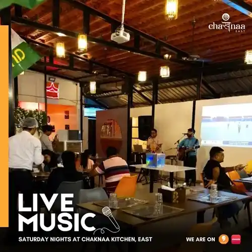 Musician performing in the restaurant as people enjoy Indian food and dhaba vibes